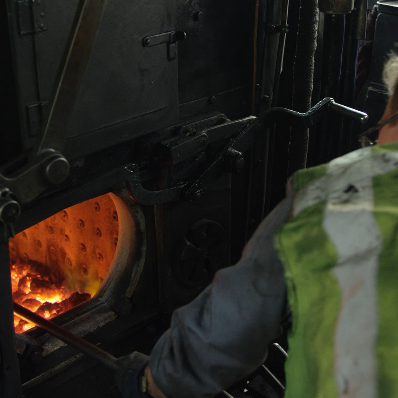 Man vult kolen bij in stoomtrein