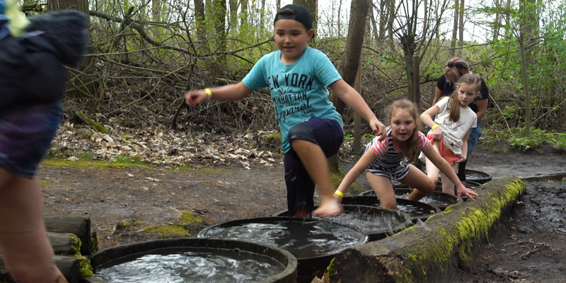 Kinderen stappen van waterton naar waterton