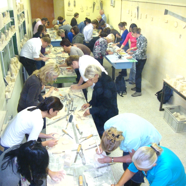 Groep mensen krijgt een  Mergelworkshop bij Mergelatelier Aarts