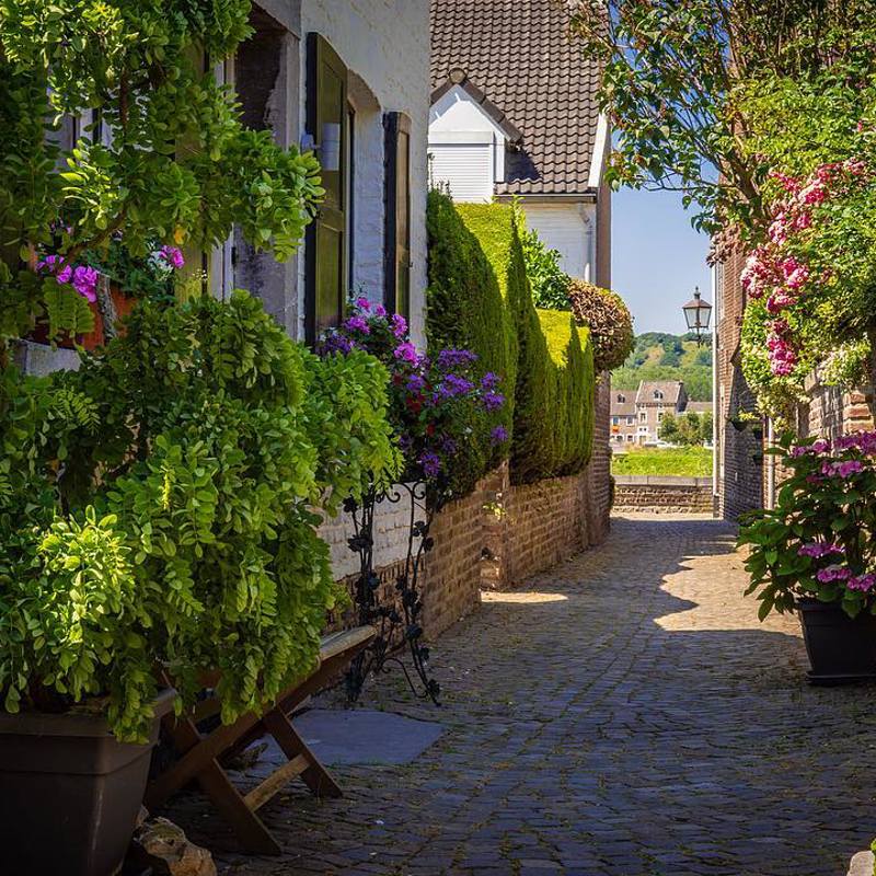 De Batsteeg met kleurrijke bloemen in Eijsden