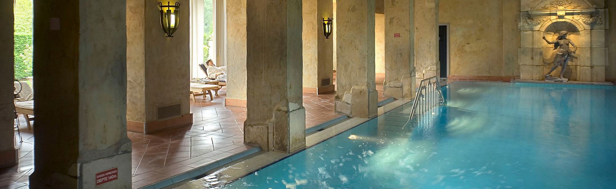 Zwembad in luxe wellness omgeving van een chateau. 