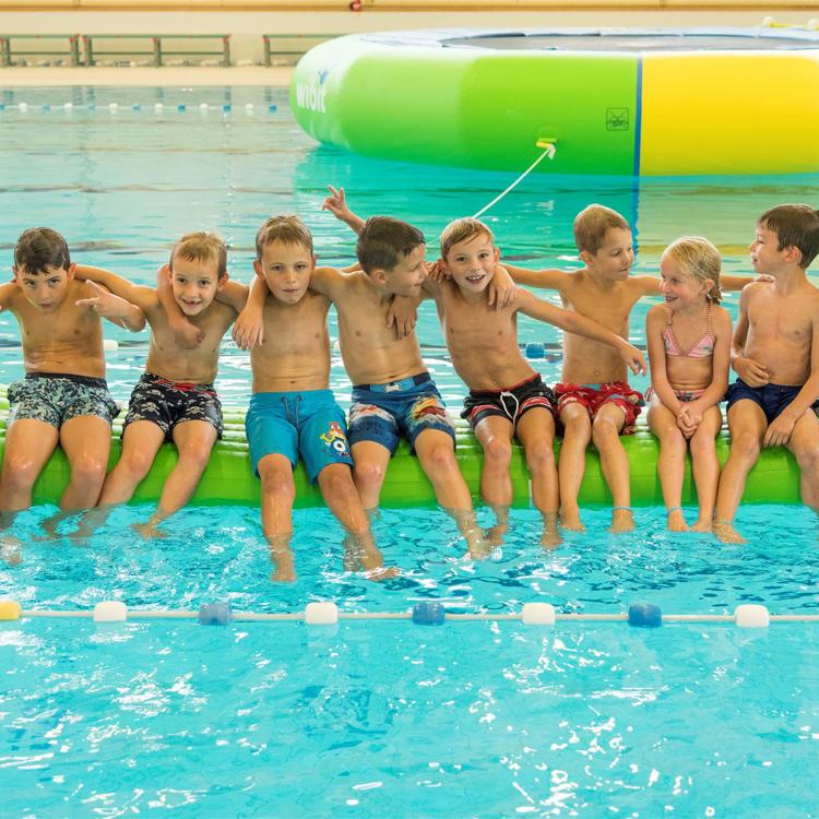 10 kinderen zitten op een rijtje in het Geusseltbad