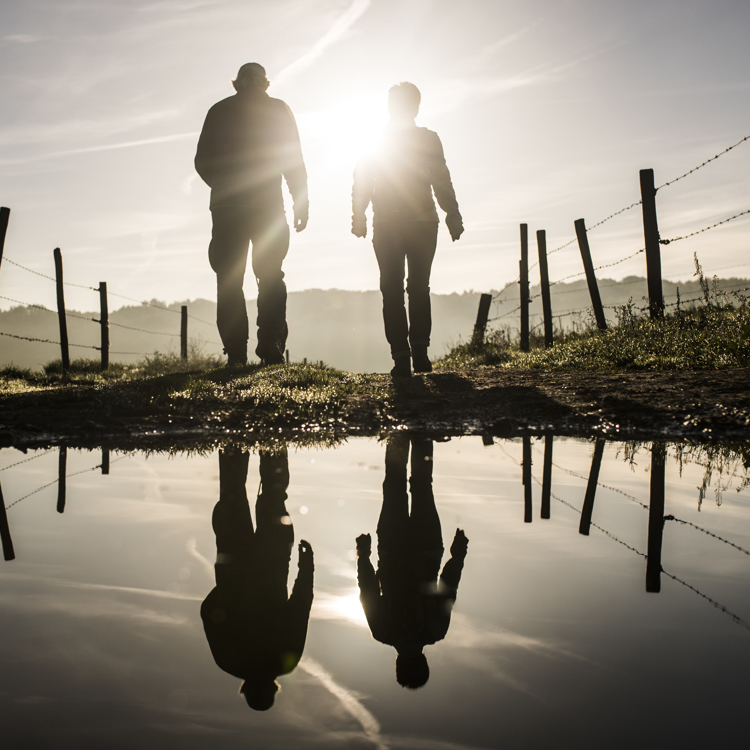 Wandelaars met reflectie in een waterplas