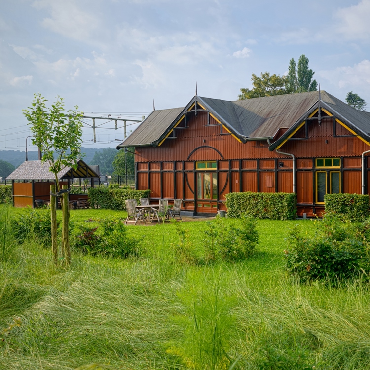 Stationsgebouw Halte St. Gerlach met groene tuin aan het spoor