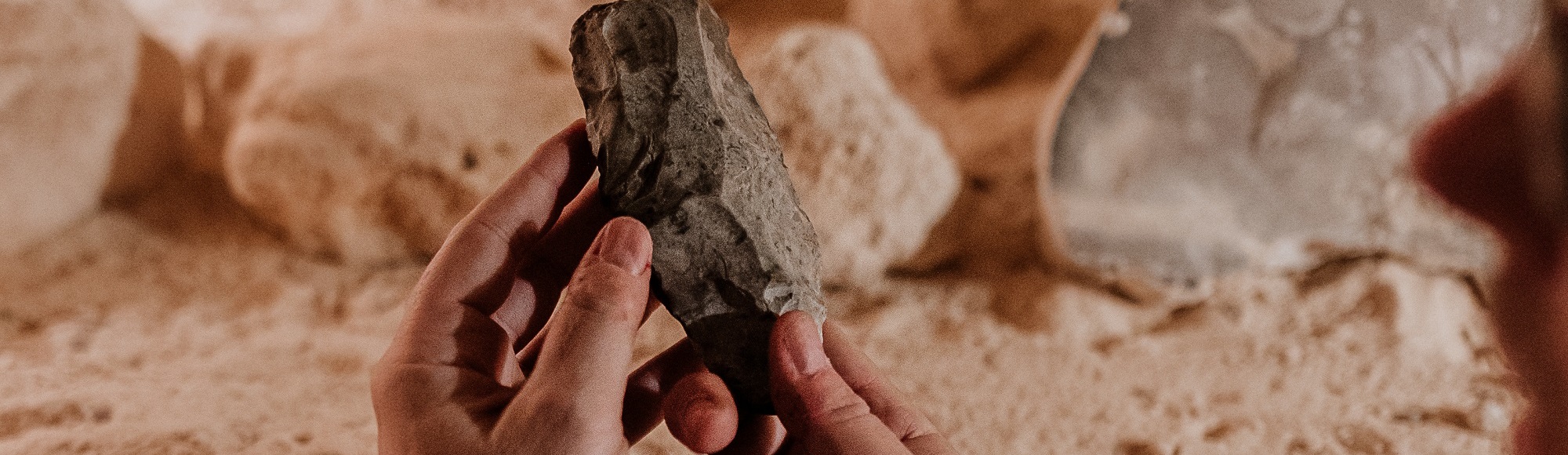 Joep Orbons houdt een ondergronds prehistorisch gesteente vast met zijn handen