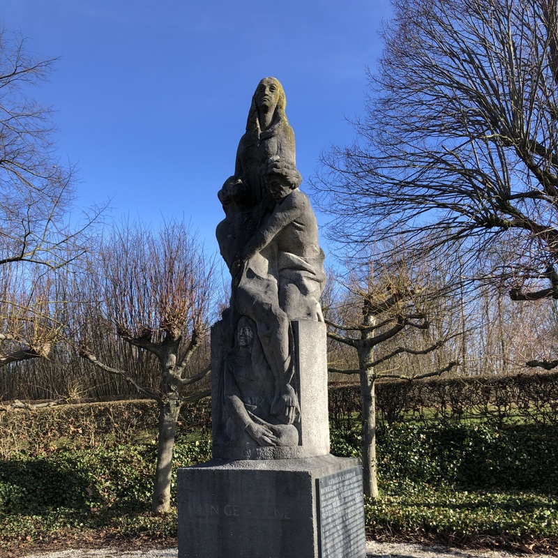 Monument Eyserlinde, plaquette met namen aan de zijkant, bomen tegen blauwe lucht